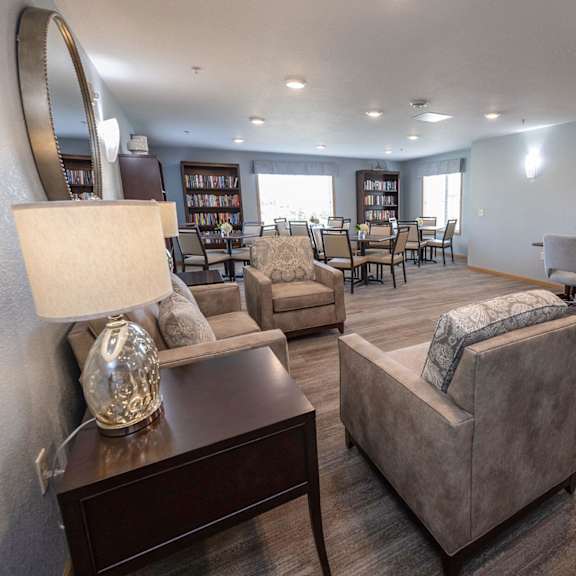 a resident clubhouse with couches chairs and tables
