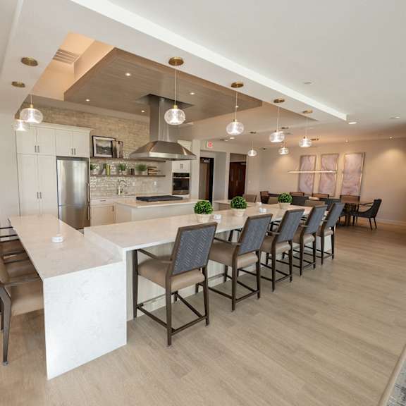 a large kitchen and dining room with a long table and chairs