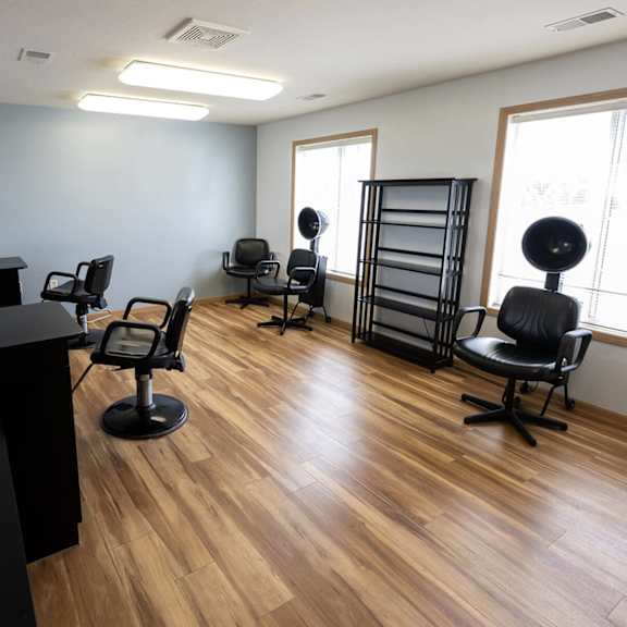a salon room with chairs and a desk