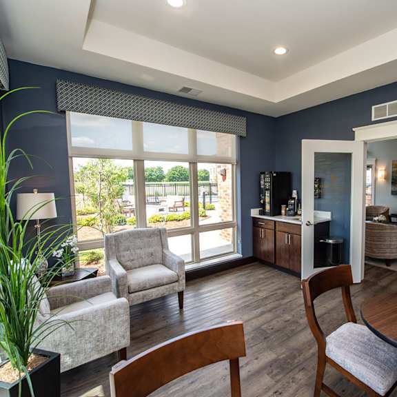 a living room with a table and chairs