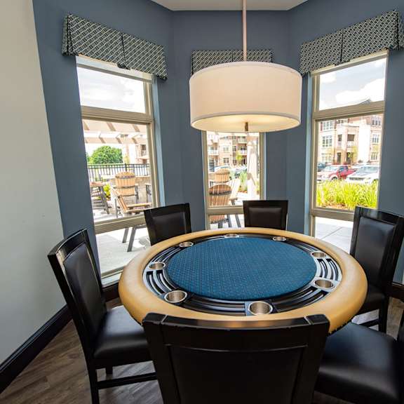 a dining room with a round table and chairs