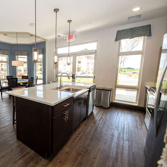 a large kitchen with an island in the middle of it