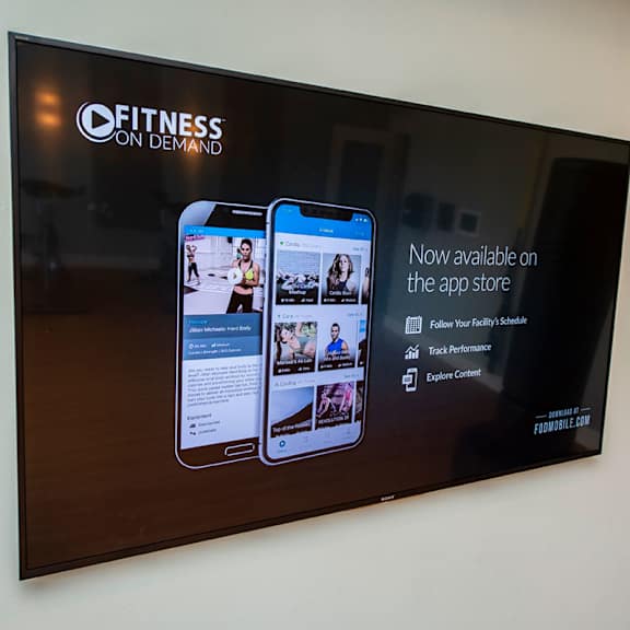 a large screen with a picture of two cell phones on a wall
