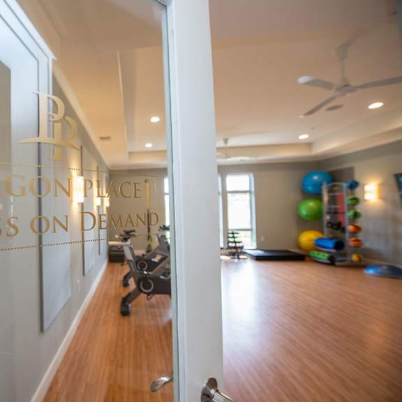 the entrance to a gym with a wall with a logo on it