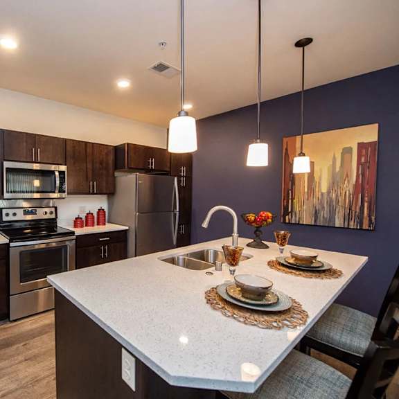 a kitchen with stainless steel appliances and a white counter top