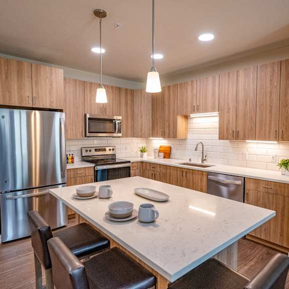 a kitchen with stainless steel appliances and a white counter top