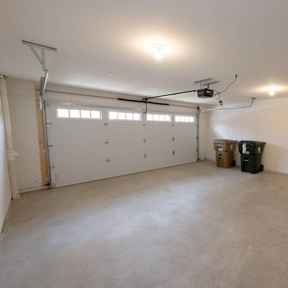 a garage with white walls and a white garage door