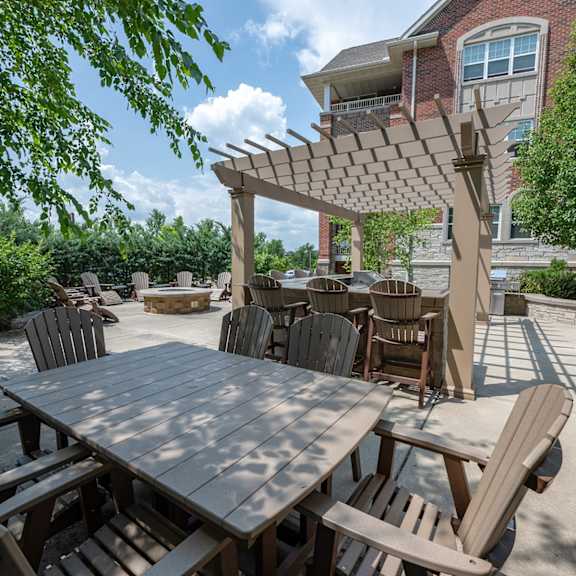 a patio with a table and chairs and a pergola