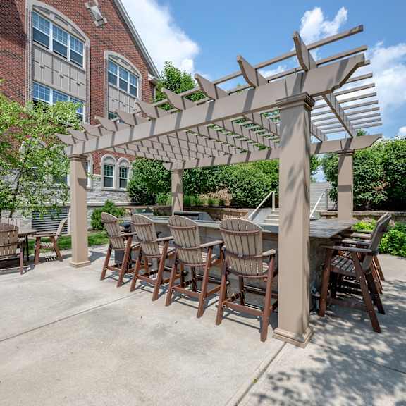 a patio with a table and chairs under a pergola