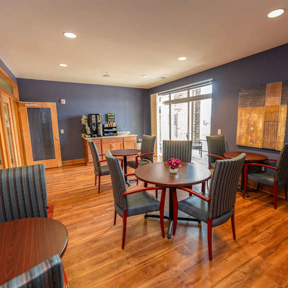 a dining room with a table and chairs and a kitchen