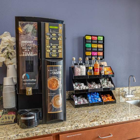 a kitchen counter with a refrigerator and a sink