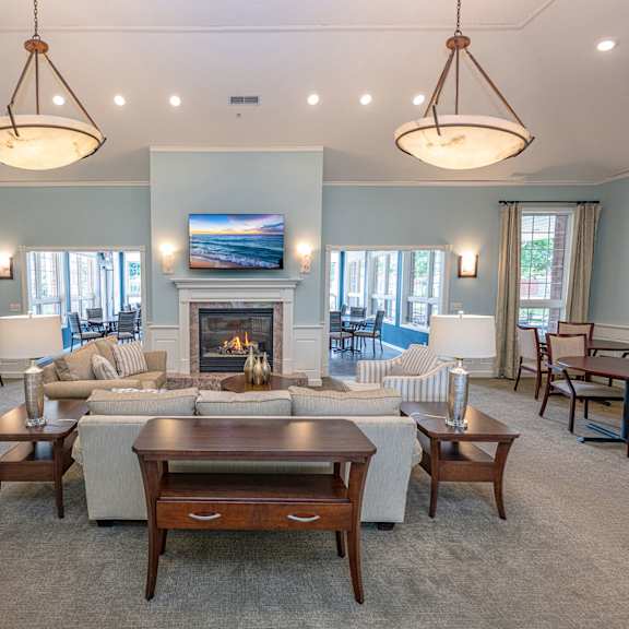 a living room with a fireplace and a television.