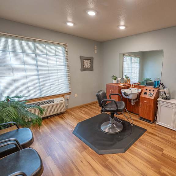 a room with a wooden floor and a table with a mirror on it.