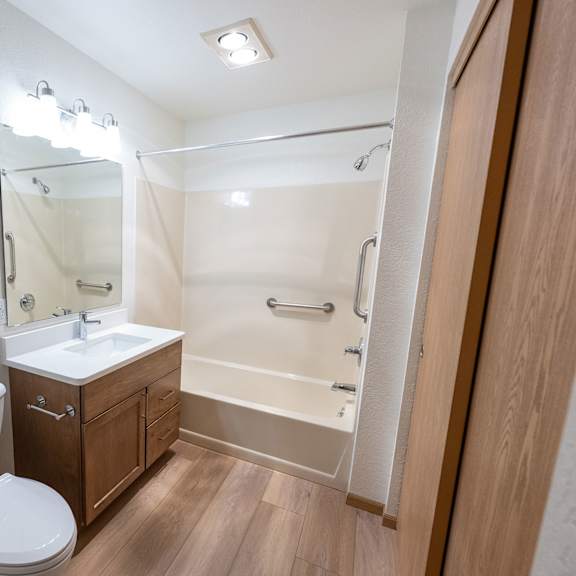 a white toilet sits next to a sink in a small bathroom.