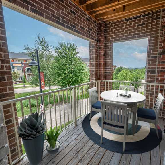 a patio with a table and chairs on a balcony