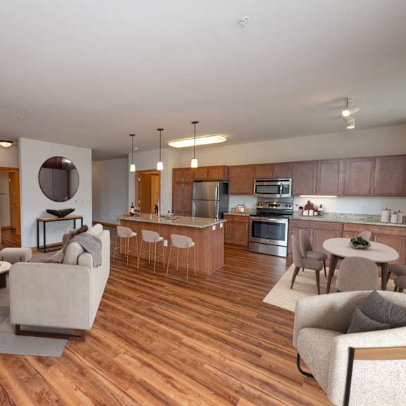 a living room with a fireplace and a dining room and kitchen