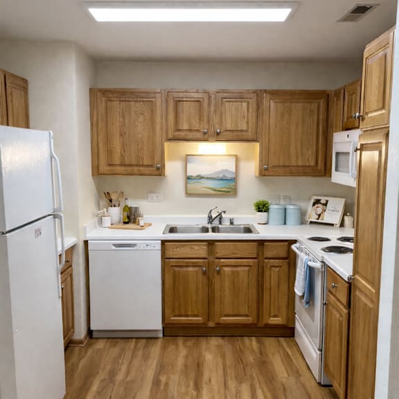 a kitchen with wooden cabinets and white appliances.