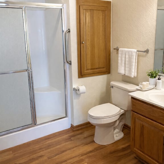 a white toilet sits next to a sink in a bathroom.
