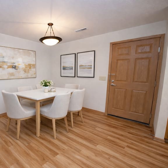 a dining room with a table and chairs.