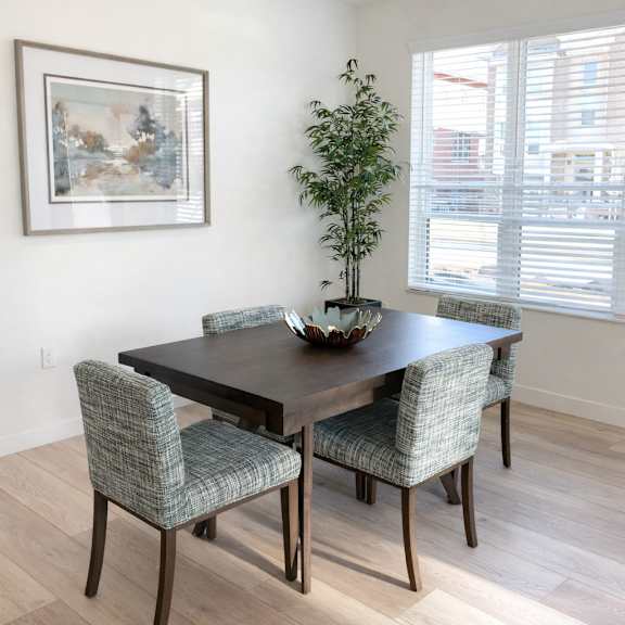 a dining room with a table and chairs.