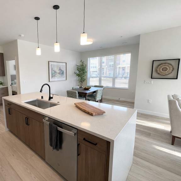 a modern kitchen with wooden cabinets and a white island.