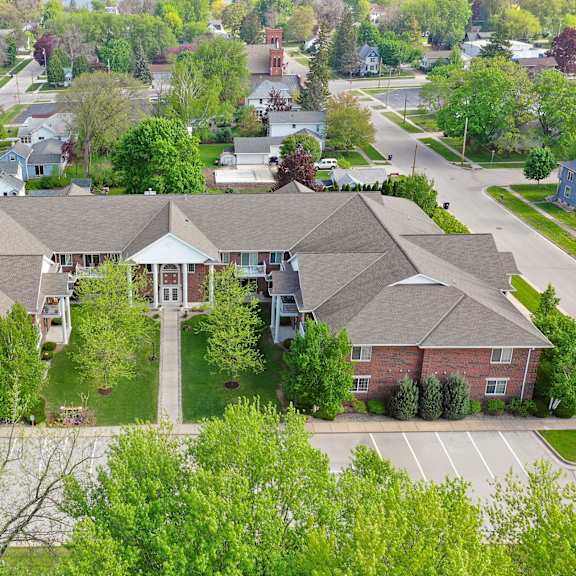 a large house with a driveway in front.
