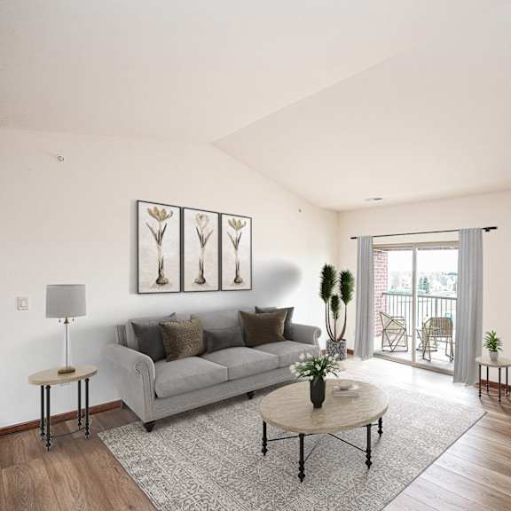 a living room with white walls and a sliding glass door leading to a balcony