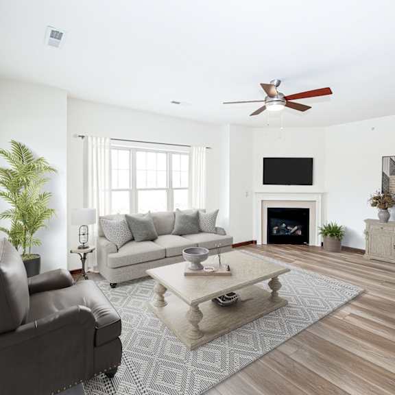 a living room with white walls and a white fireplace with a tv above it