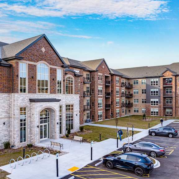 a large building with cars parked in a parking lot