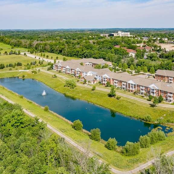 a large building complex with a lake in front.
