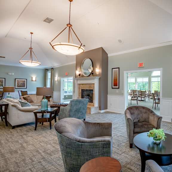 a living room with a grey couch and a fireplace.