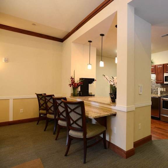 community room kitchen and breakfast bar at highlands at riverwalk apartments 55+, mequon, wi,53092
