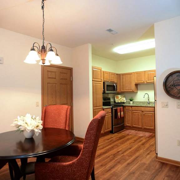 separate dining area with modern lighting at highlands at riverwalk apartments 55+, 10954 n cedarburg road, mequon, wi 53092