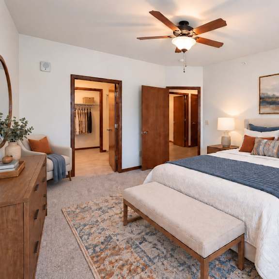 a bedroom with a large bed and a ceiling fan.