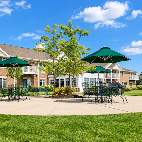 a large building with a green lawn in front.