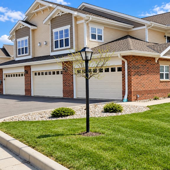 a row of houses with a green lawn in front.