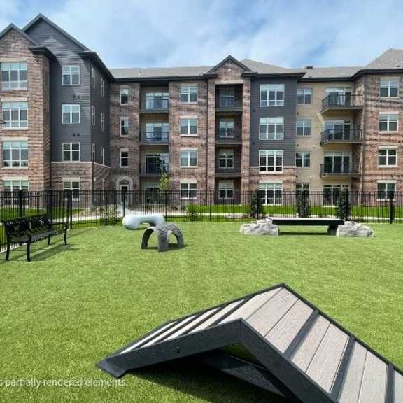 a large apartment complex with a playground in front.