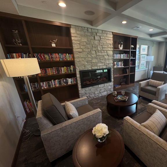 a living room with a stone fireplace and leather couches.