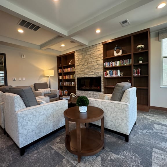 a living room with a grey carpet and a white sofa.