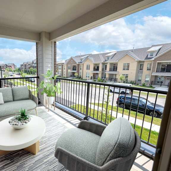 a living room with couches and a table on a balcony