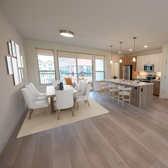 an open living room and kitchen with a dining room table and chairs