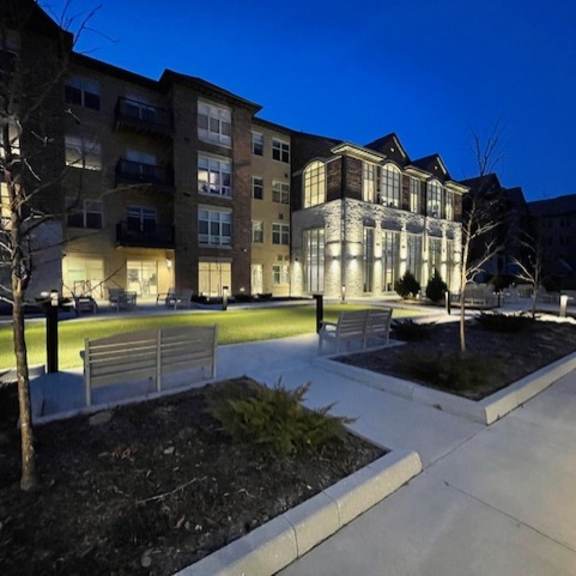 a building with a lit up walkway in front of it.