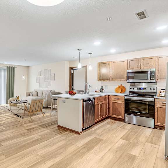 a kitchen with wooden cabinets and a white countertop.