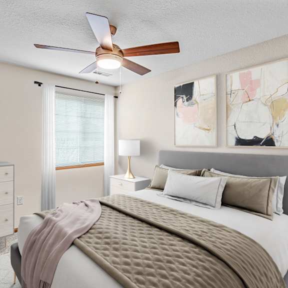 a bedroom with a bed, dresser, and ceiling fan.