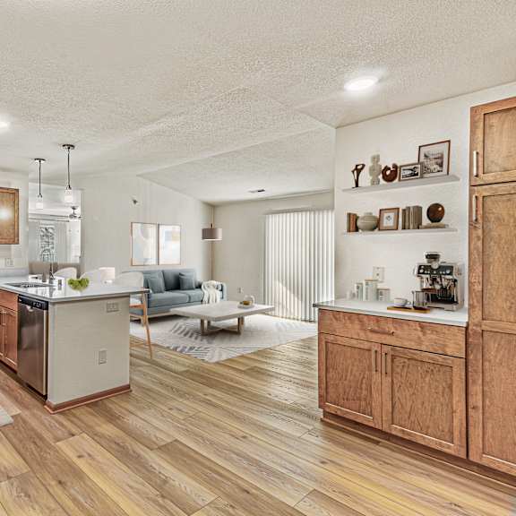 a kitchen with wooden floors and a refrigerator on the left.