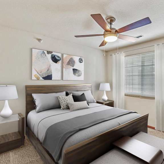 a bedroom with a bed, nightstand, and a ceiling fan.