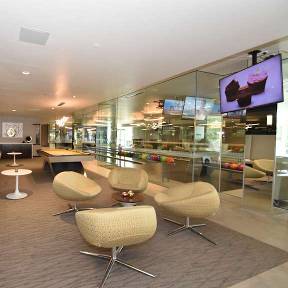game room with pool table and curved swivel seating at 360 luxury apartments, san diego, california