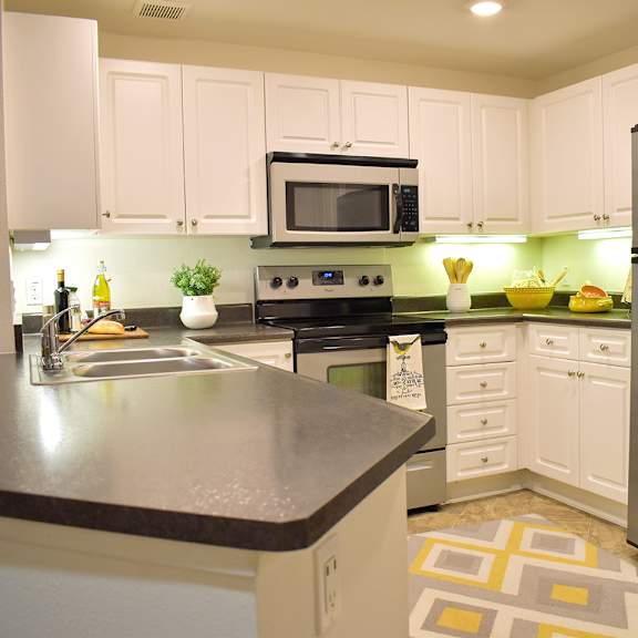 spacious kitchen with pantry cabinet at casa mira view apartments, san diego