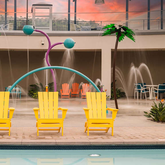 yellow chairs near pool at casa mira view apartments, california