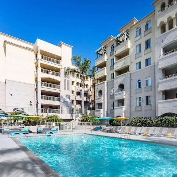 a swimming pool in front of apartment buildings. at la jolla crossroads apartments, san diego, california